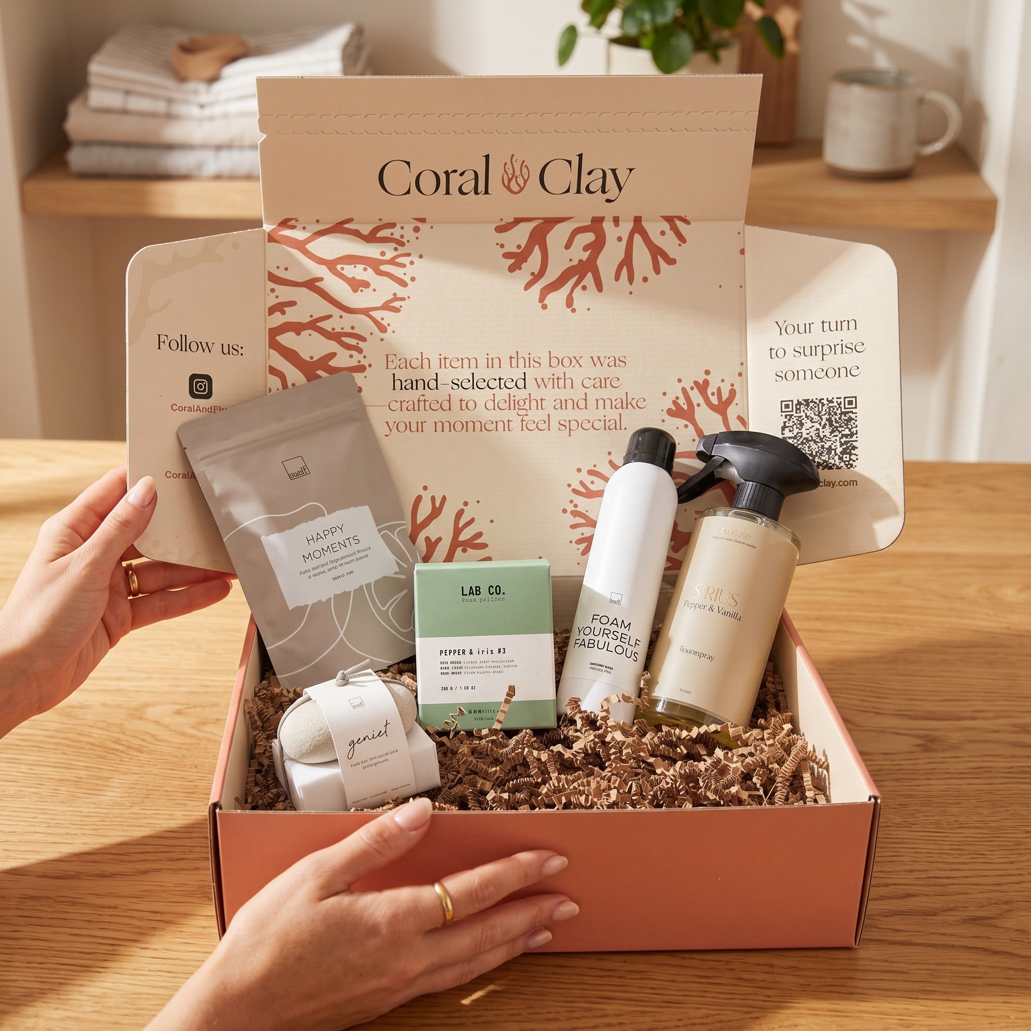 Coral Clay gift box with various items on a wooden surface