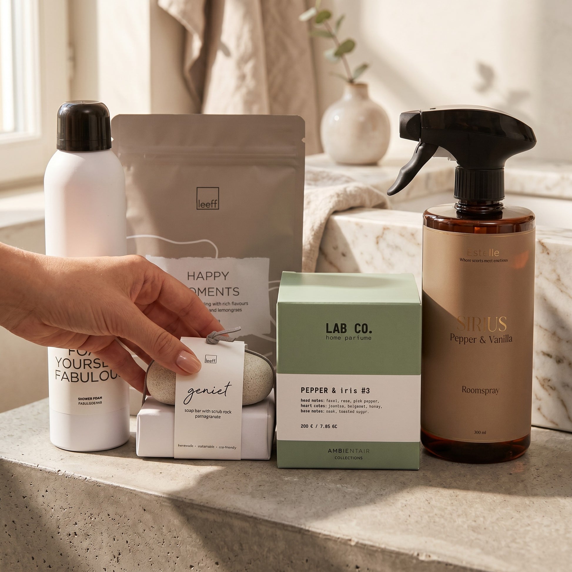 Collection of skincare and wellness products on a surface with a hand holding a product.