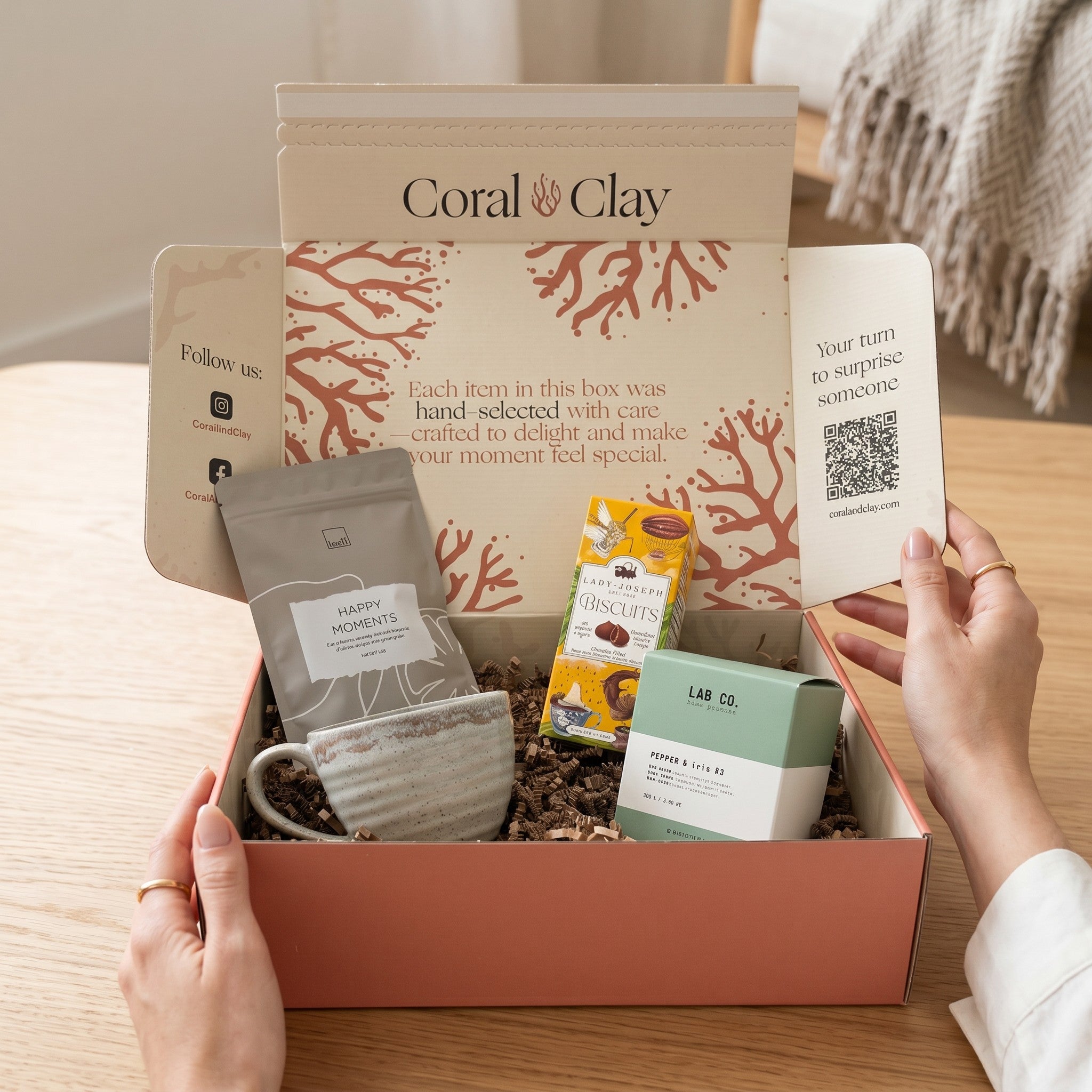 Coral Clay gift box with various items on a wooden surface