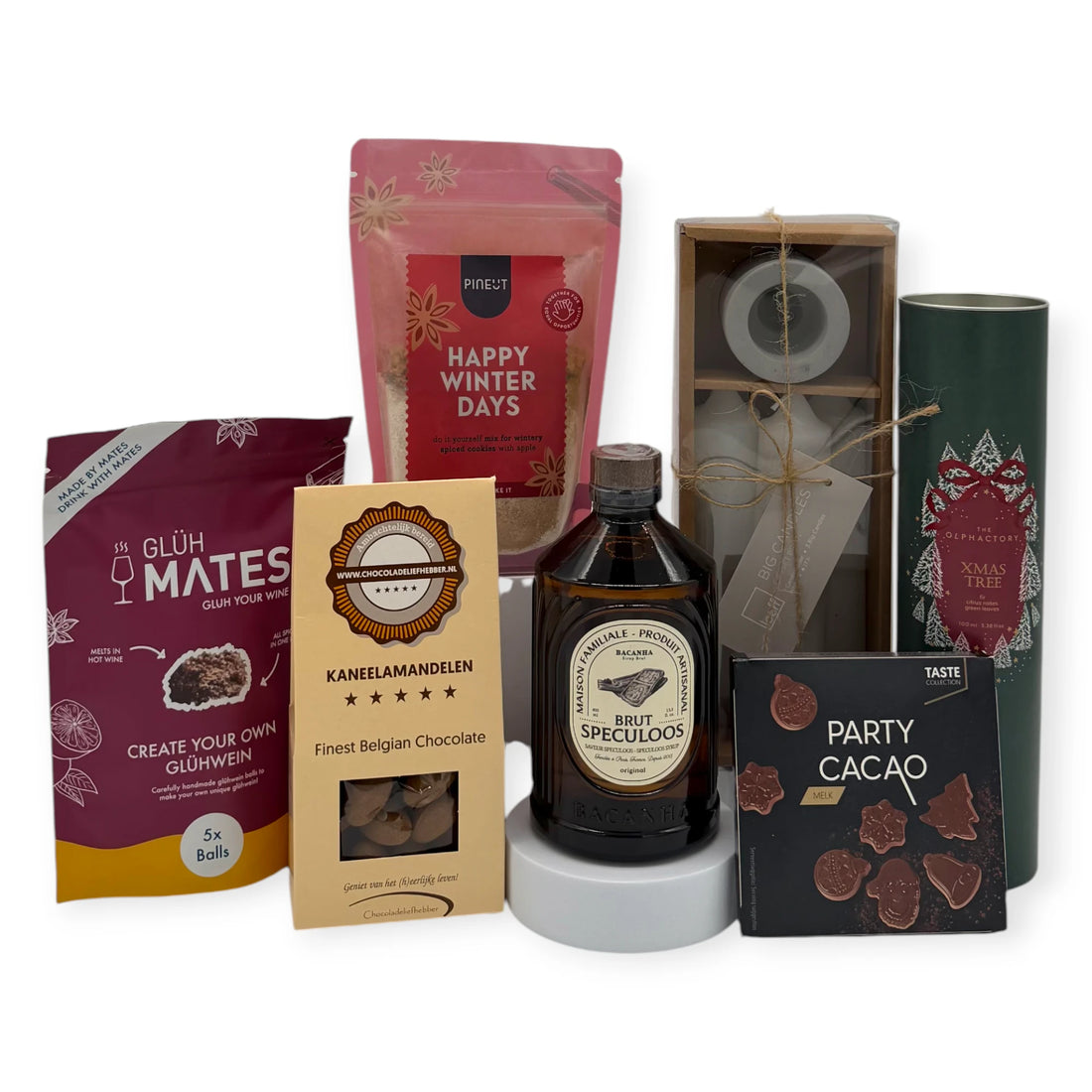 Grand Happy Santa Gift Box presented with festive treats including Happy Winter Days cookie mix, Glüh Mates mulled wine spices, Brut Speculoos liqueur, cinnamon almonds, Belgian chocolate party shapes, taper candles, and an Xmas Tree diffuser arranged around a Coral & Clay Christmas gift box.