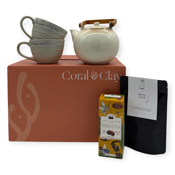 Grand Tea Ritual Gift Box displayed on Coral & Clay signature coral-coloured box with ceramic teapot, stacked stoneware mugs, Lady Joseph biscuits, and Leeff ‘With Love’ herbal tea.”