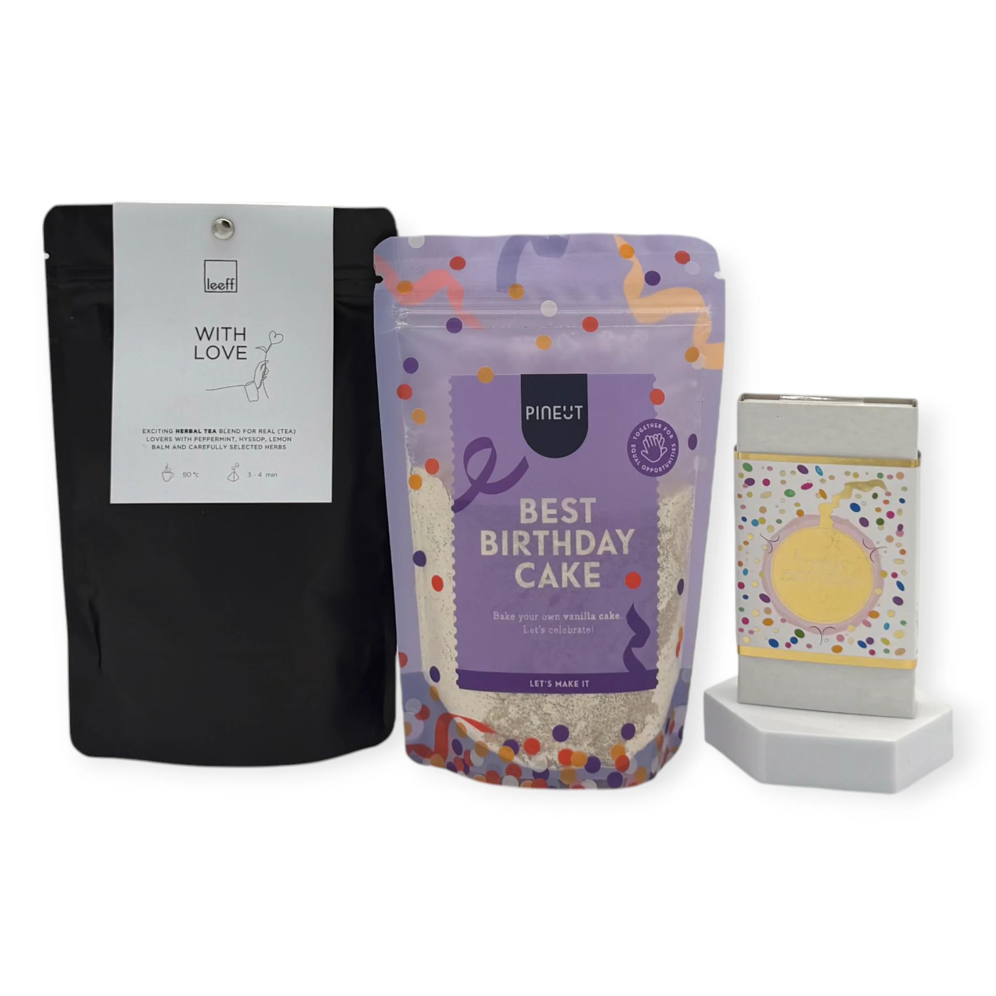 Contents of the Coral & Clay Birthday Moments Letterbox Gift featuring Pineut Best Birthday Cake mix, Leeff With Love herbal tea, and a confetti-wrapped birthday chocolate bar.