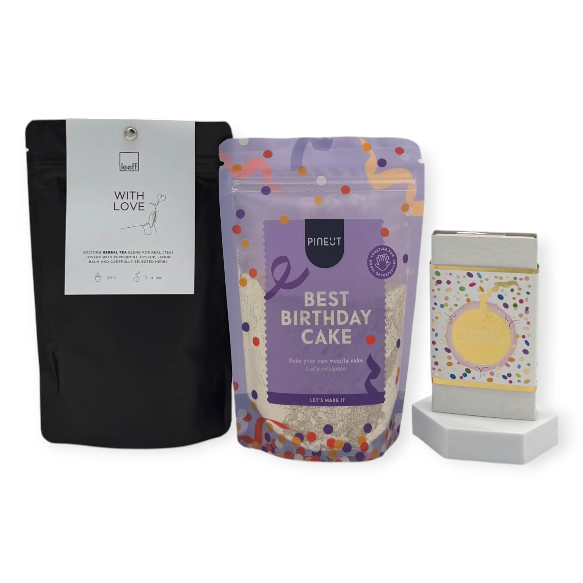 Contents of the Coral & Clay Birthday Moments Letterbox Gift featuring Pineut Best Birthday Cake mix, Leeff With Love herbal tea, and a confetti-wrapped birthday chocolate bar.