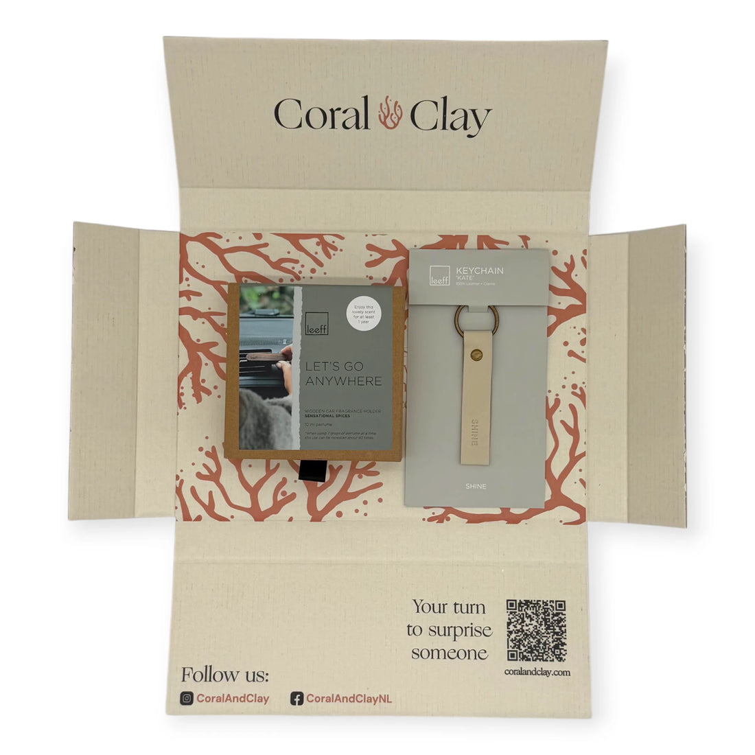 Coral & Clay On the Go Letterbox Gift displayed with a Leeff car fragrance holder and a heart-shaped leather keychain.