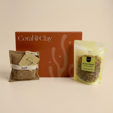 Coral & Clay Letterbox gift box with a compact selection of wellness items, including a burlap pouch labeled ‘hug’ and a facial steam blend in a resealable bag. Minimalist coral-themed packaging creates a warm, thoughtful presentation.