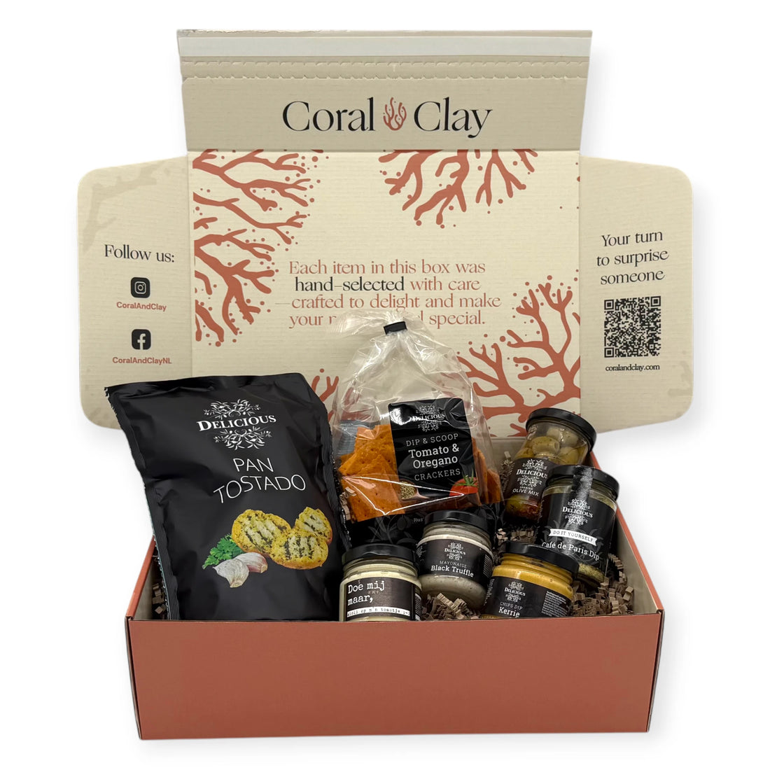 Dutch Borrel Signature Gift — hero setup featuring Pan Tostado, Tomato & Oregano Crackers, dips, and olives in front of the Coral & Clay signature gift box.