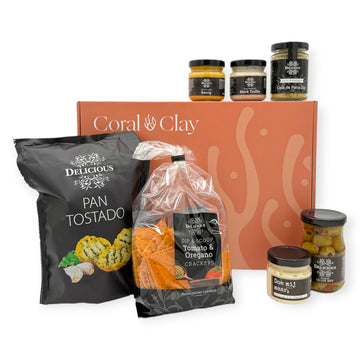Dutch Borrel Signature Gift — hero setup featuring Pan Tostado, Tomato & Oregano Crackers, dips, and olives in front of the Coral & Clay signature gift box.