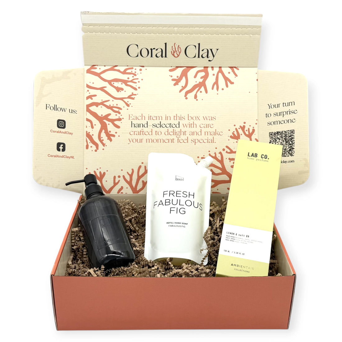 Signature Hands & Home gift set arranged in front of a Coral & Clay signature box, showing Fresh Fabulous Fig hand soap refill, black glass soap dispenser, and Lab Co Lemon & Salt home perfume.