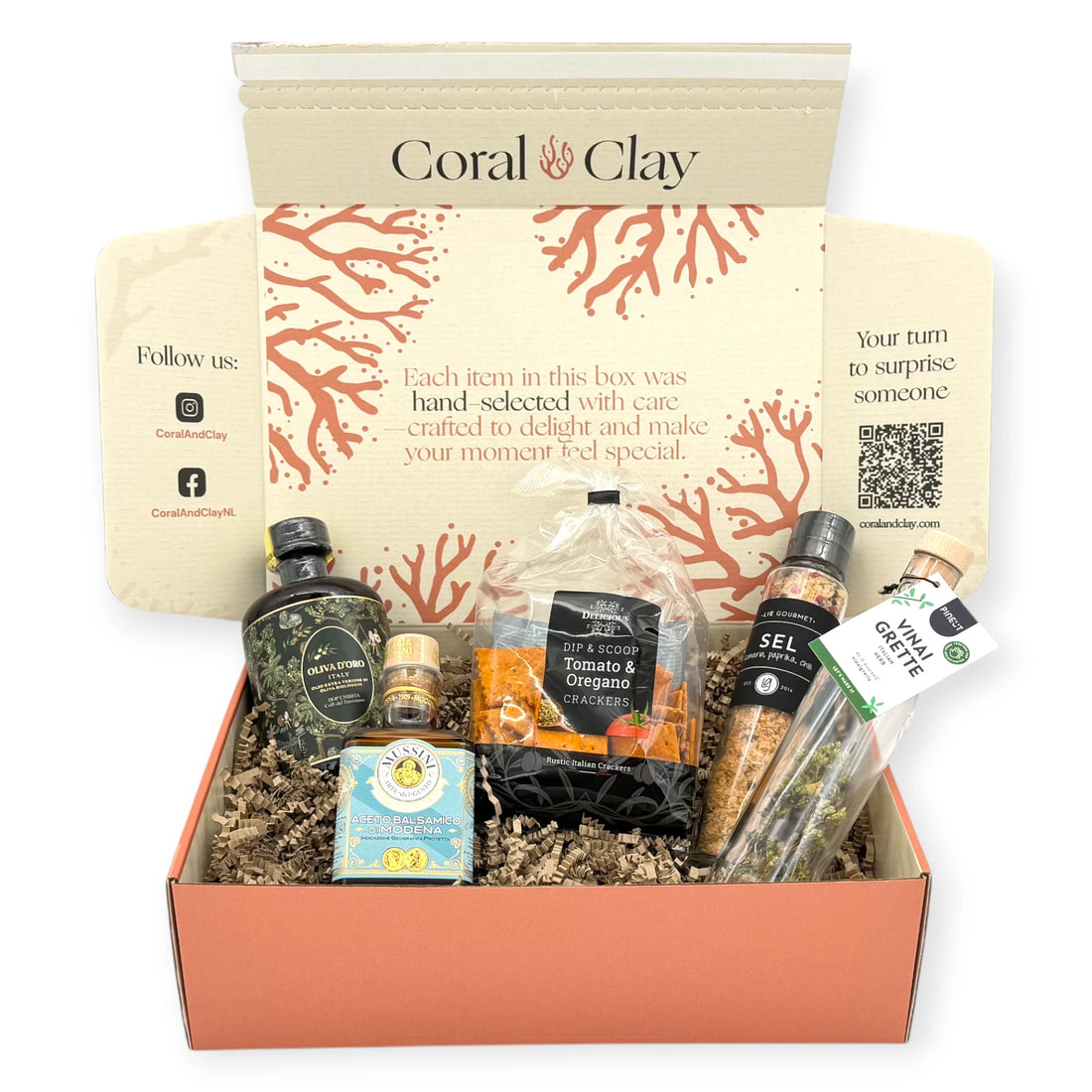 Coral & Clay Signature box surrounded by Italian antipasti items including Italian vinegar, herbed vinaigrette, tomato and oregano crackers, and gourmet salt.