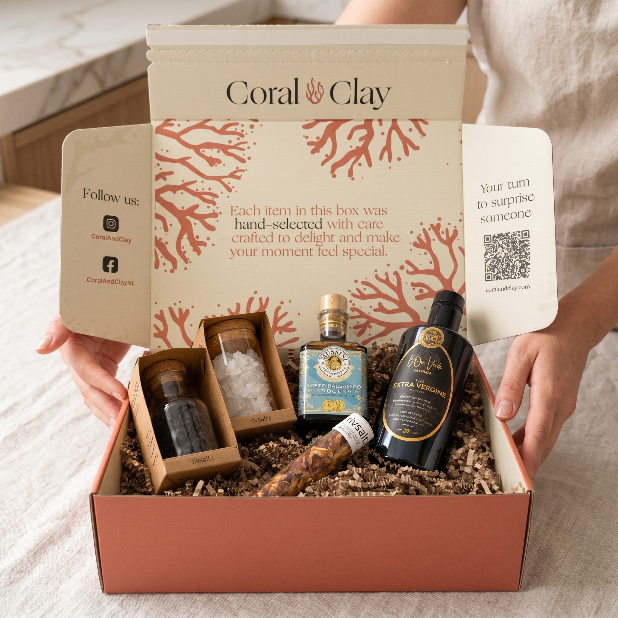 Coral & Clay Premium Kitchen Essentials Signature Gift lifestyle photo – kitchen counter scene with Mussini Modena balsamic vinegar, Oliva D’Oro olive oil, Rivsalt Pasta Salt rocks, Amazon Chili and Java Long Pepper in the signature gift box.