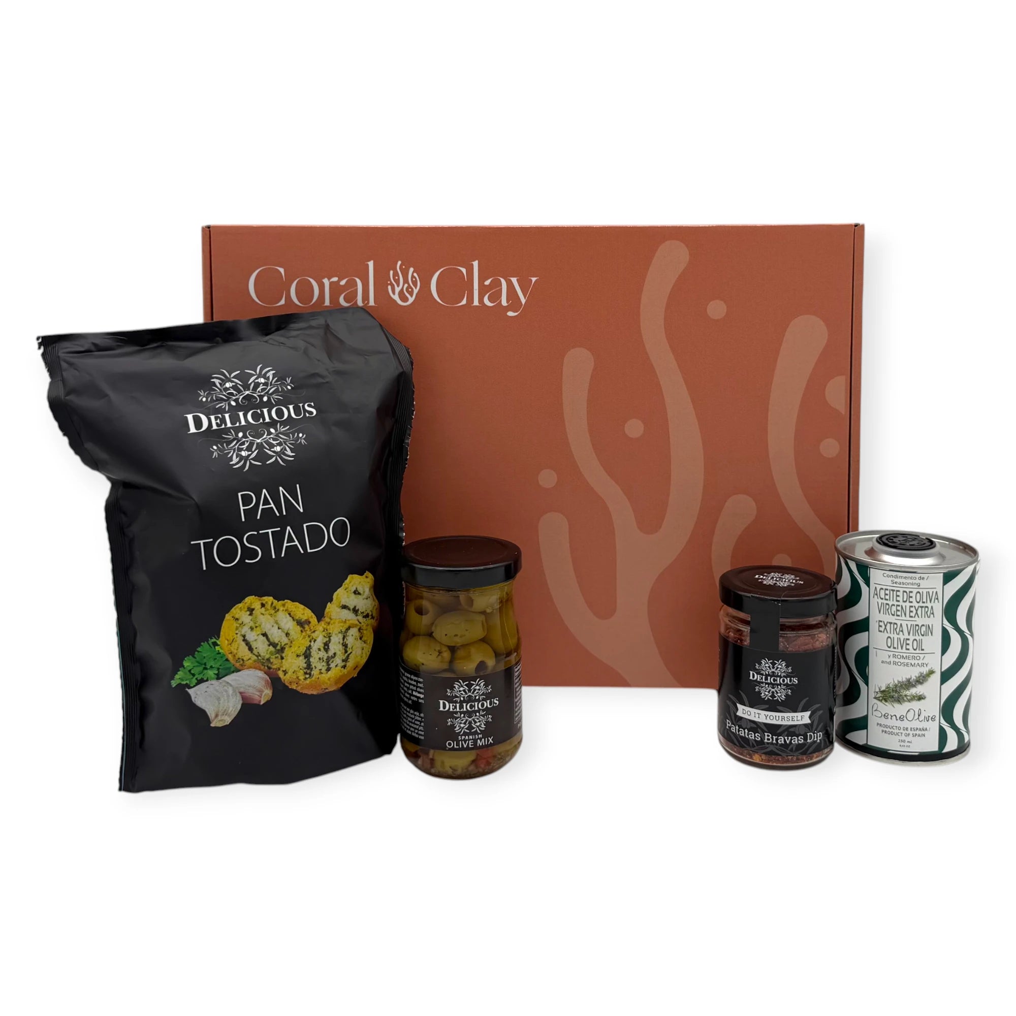 Taste of Spain gift box with Pan Tostado crispbread, seasoned olive mix, Patatas Bravas dip mix, and BeneOlive rosemary olive oil arranged in front of the closed Coral & Clay signature box.
