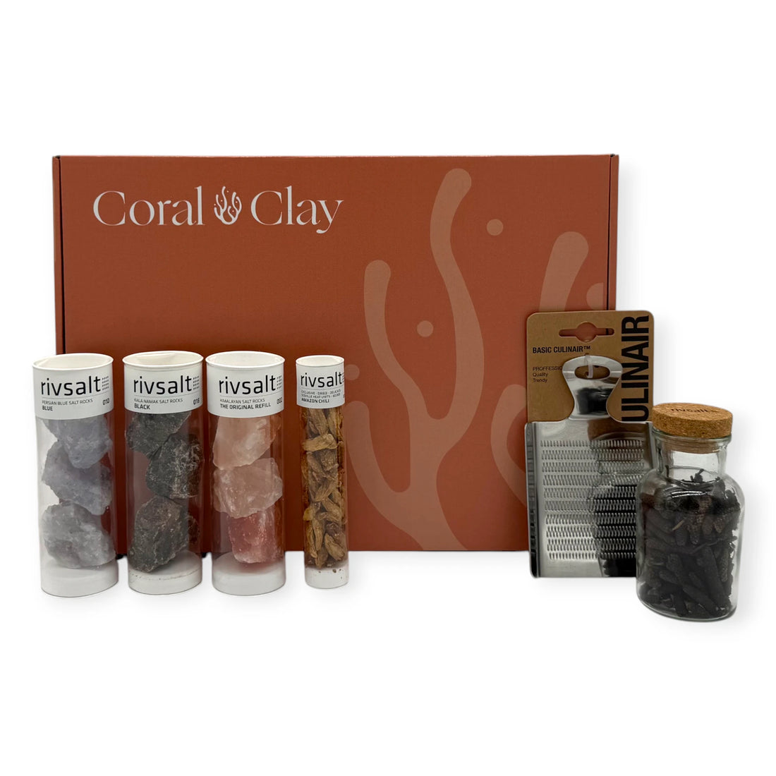 Coral & Clay Signature Spiceworks Gift Box with Rivsalt salt rock tubes, Amazon chili tube, whole spice jar, and stainless-steel grater arranged in front of the terracotta gift box.